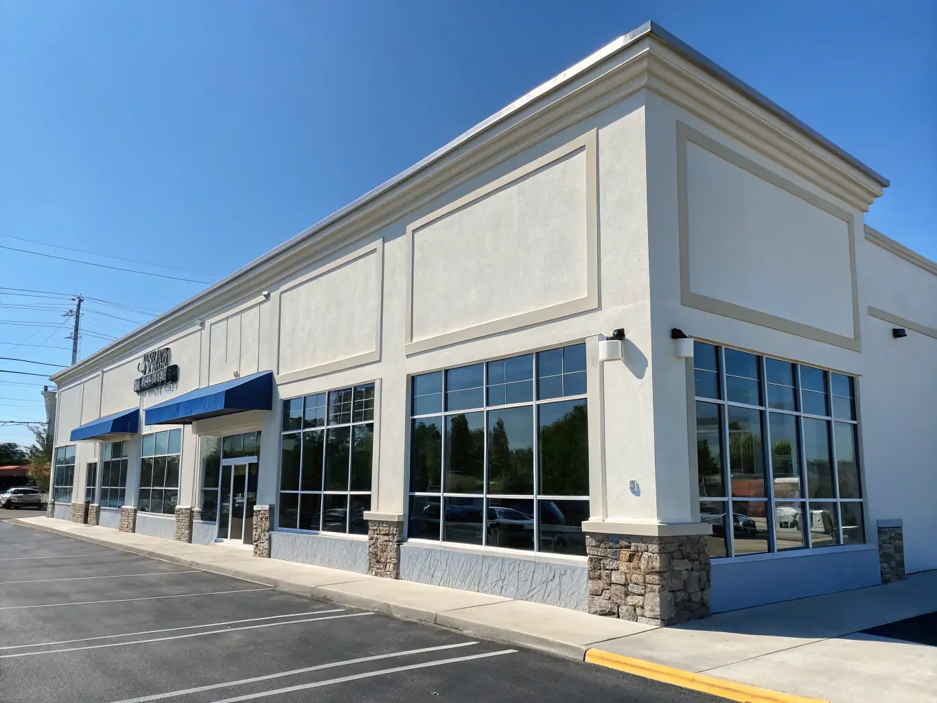 A commercial building with a pristine exterior and clean parking lot, demonstrating the impact of commercial power washing.